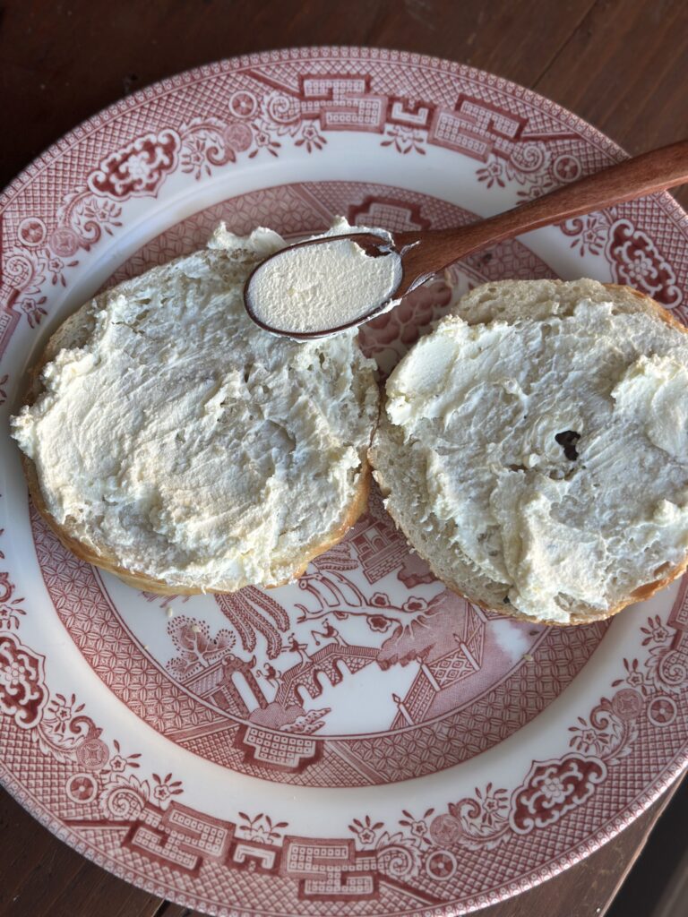 Delicious cream cheese spread on a sourdough bagel