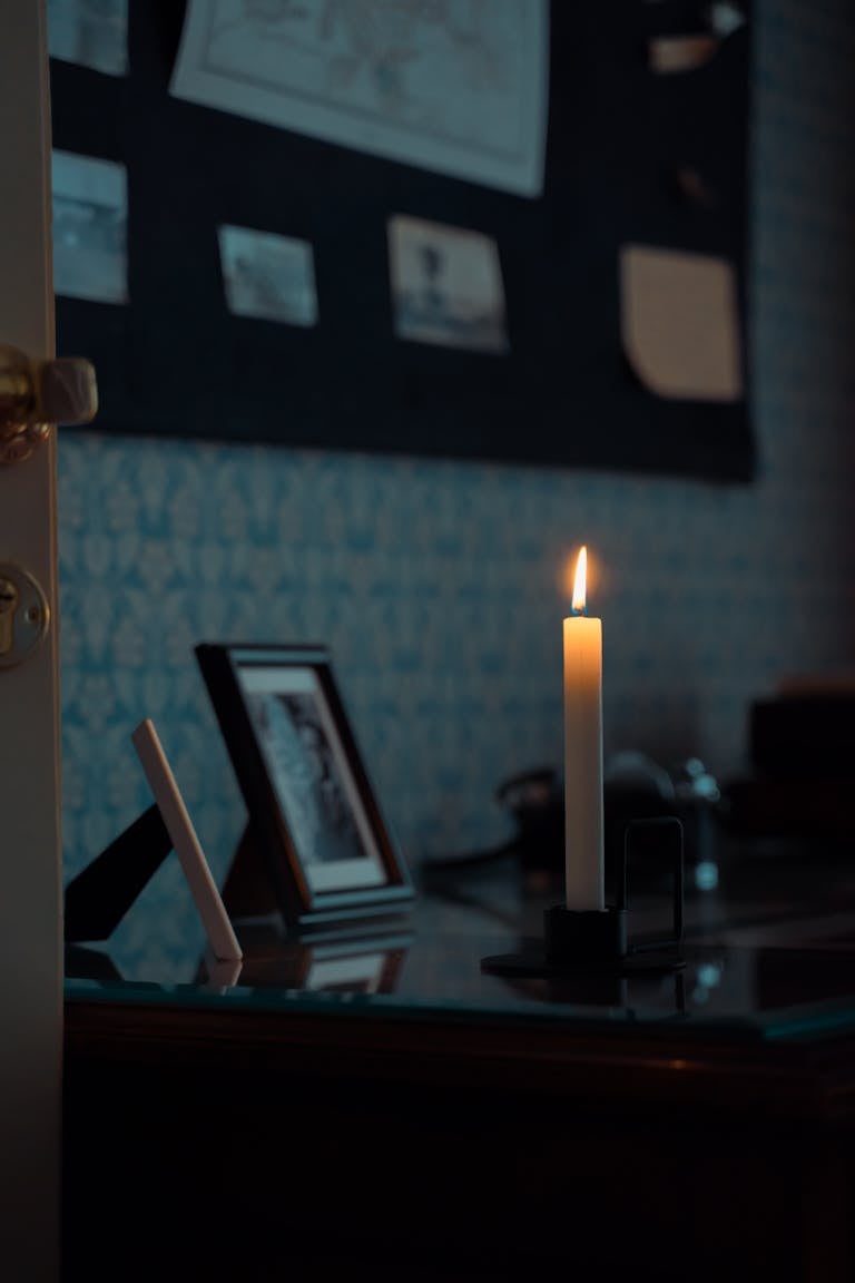 traditional desk with lit candle, maybe a hop chest in the corner