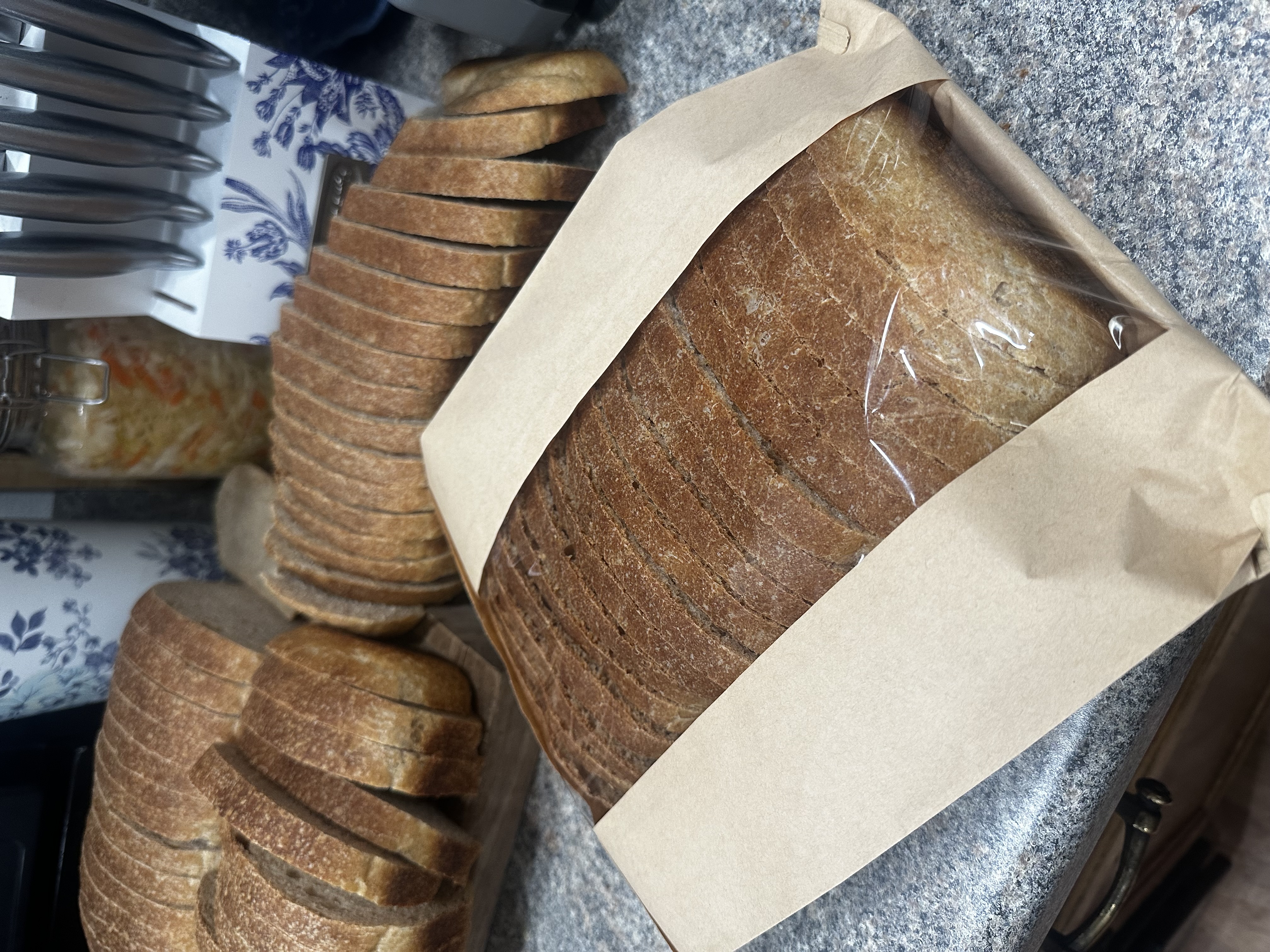 homemade sourdough sandwich bread packaged in a Kraft paper bag to take to a farmers market party 